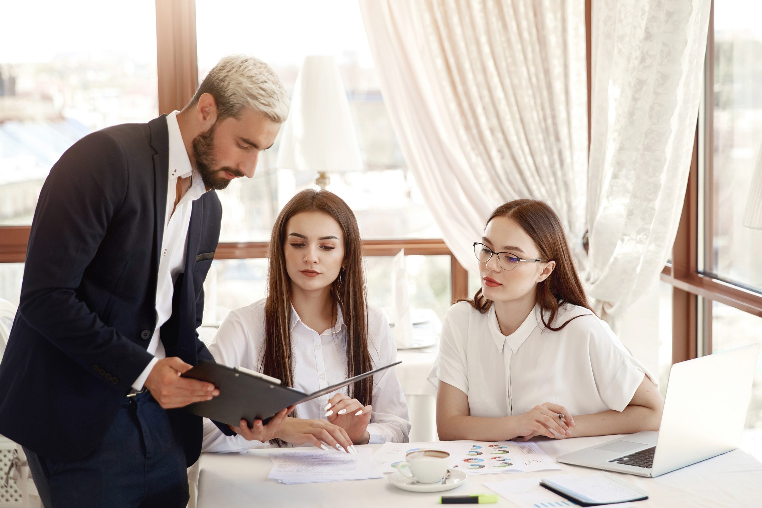 restaurant-director-is-showing-financial-diagrams-documents-two-assistants-women-are-listening-with-attention-1